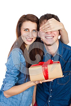 Happy Young beautiful Couple isolated on a White background with gift in hand