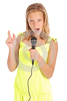 Happy young beautiful girl singing with microphone