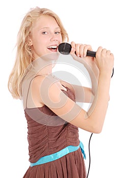 Happy young beautiful girl singing with microphone