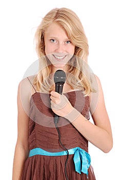 Happy young beautiful girl singing with microphone