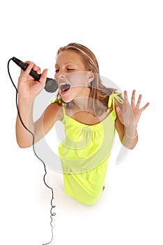 Happy young beautiful girl singing with microphone