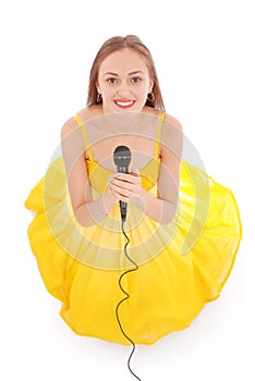 Happy young beautiful girl singing with microphone