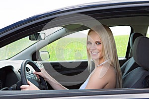 Happy Young Beautiful Woman Driving Car