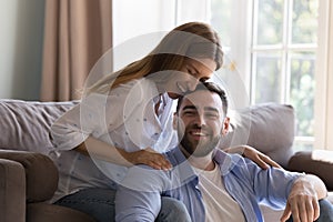 Happy young beautiful woman and handsome man relaxing at home