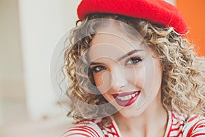 Happy young beautiful woman taking selfie on blurred background