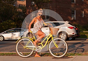 Happy young bicyclist riding in city.