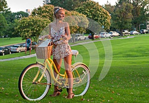 Happy young bicyclist riding in park.