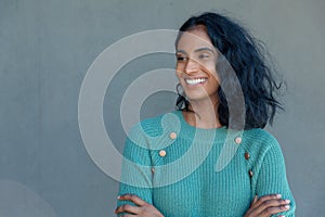 Happy young biracial female advisor looking at copy space against gray wall