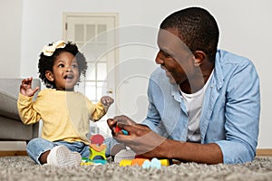 Happy Young Black Father Playing Together With Little Baby Daughter