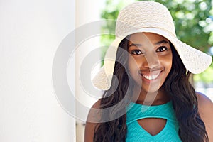 Happy young black girl with long hair and sun hat