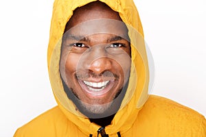 Happy young black man with raincoat against isolated white background