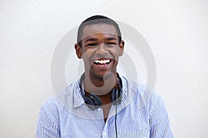 Happy young black man smiling with headphones