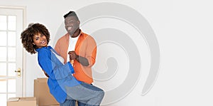 Happy Young Black Spouses Dancing Together In Bright Room While Moving Home