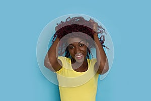 Happy Young Black Woman Is Holding Hands In Hair