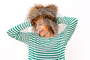 Happy young black woman laughing with hand in hair