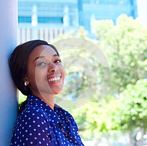 Happy young black woman smiling outdoors