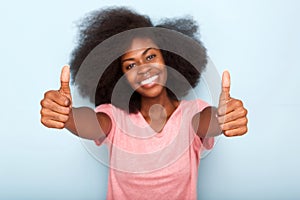 Happy young black woman with thumbs up hand sign