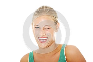 Happy young blond woman blinking.