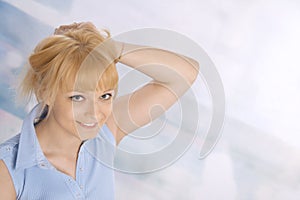 Happy young blond woman in a blue shirt