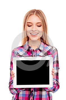 Happy young blonde girl showing blank tablet screen