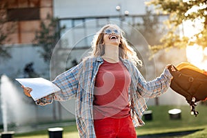 Happy young blonde woman student celebrate success after exams in university.