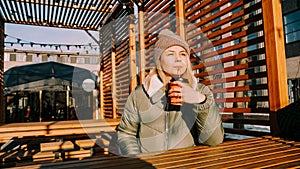 Happy young blonde woman on a winter sunny day at a street food fair