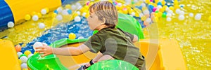 Happy young boy on the boat enjoying playing on amusement park BANNER, LONG FORMAT