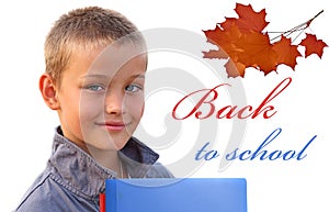 Happy young boy with books looking at camera on wh