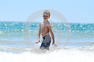 Happy young boy enjoying the sea side