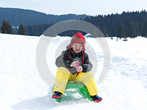 Happy young boy have fun on winter vacatioin on fresh snow