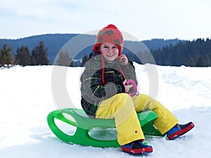 Happy young boy have fun on winter vacatioin on fresh snow