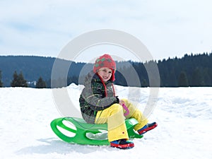 Happy young boy have fun on winter vacatioin on fresh snow