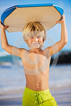 Happy Young boy having fun at the beach on vacation,