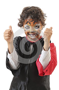 Happy young boy with his face painted like a tiger