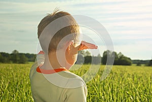 Happy young boy looking horizon and dreaming