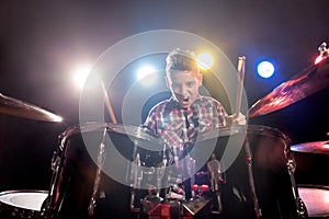 Young boy playing drums