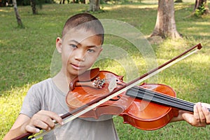 Happy young boy plays his violin