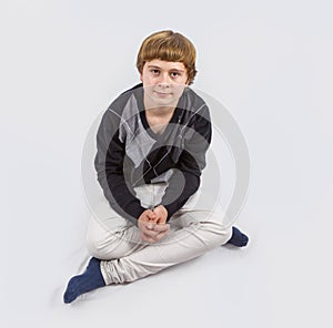 Happy young boy posing in studio