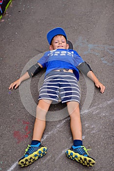 Happy young boy relaxing on his skateboard