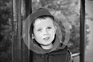 Happy young boy smiling in an outdoor scene