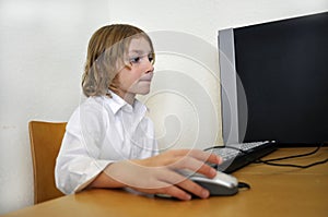 Happy Young Boy Using a Computer
