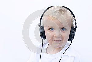 Happy young boy wearing headphones