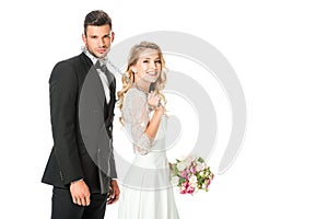 happy young bride with chain and leashed groom looking at camera