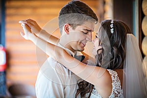 Happy young bride and groom going to kiss