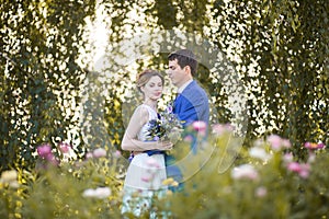 Happy young bride and groom on  wedding day. Wedding couple - new family! wedding dress. Bridal wedding bouquet of flowers