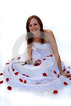 Happy young bride with rose petals