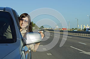 Happy young brunette driving