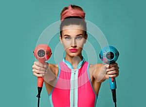 Happy young brunette woman with hair dryer on blue mint background photo