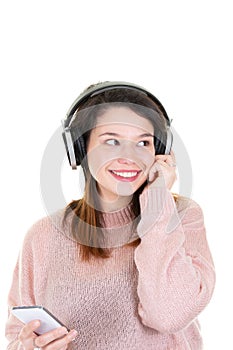 Happy young brunette woman with headphones on white background