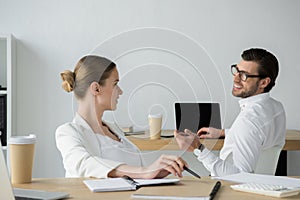 happy young business colleagues chatting at workplace photo